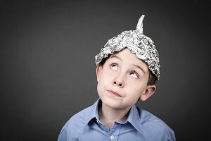 Boy in a tin foil hat looking up
